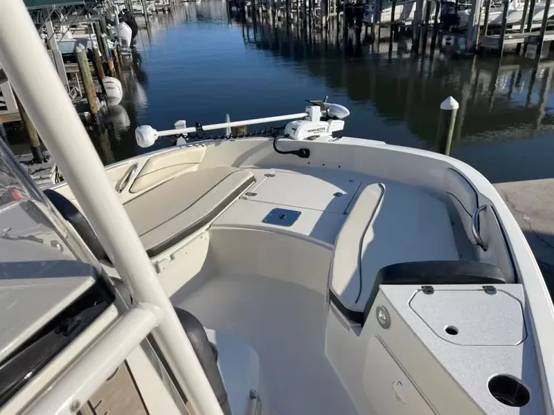 Slide: The Image of 2023 Stingray 206 CC boat at dock with seating area. - 10