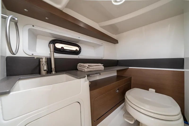 Slide: The Image of Manufacturer Provided Image: 2023 Sea Ray SDX 290 boat bathroom with sink, toilet, and storage. - 12