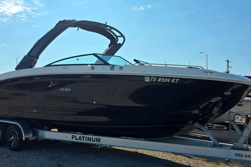 Slide: The Image of 2023 Sea Ray SDX 290 boat on trailer under clear blue sky. - 15