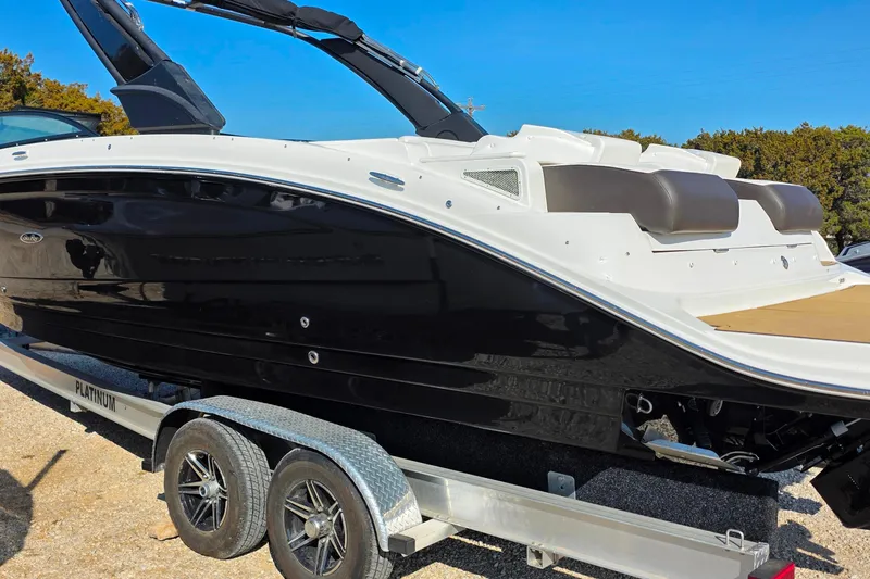 Slide: The Image of 2023 Sea Ray SDX 290 boat on trailer, sleek black and white design. - 17