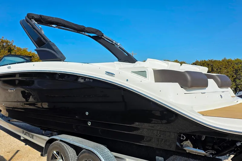 Slide: The Image of 2023 Sea Ray SDX 290 boat on trailer, sleek black and white design. - 18