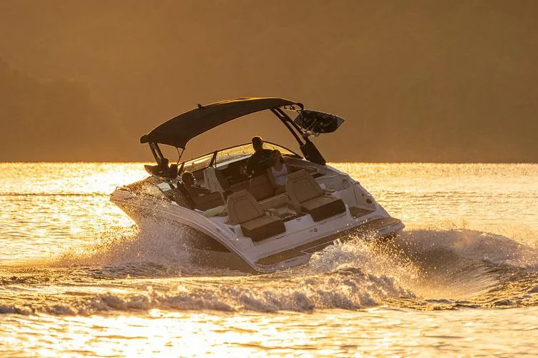 Slide: The Image of Manufacturer Provided Image: 2023 Sea Ray SDX 290 boat cruising at sunset on a lake. - 2