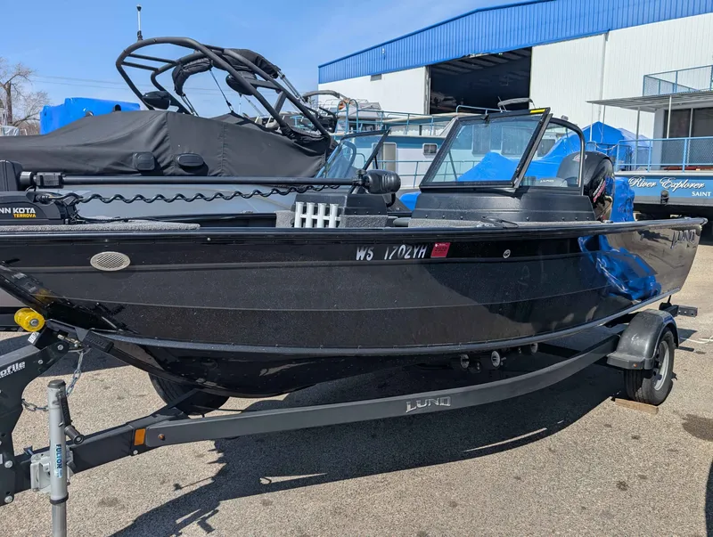 Slide: The Image of Black 2023 Lund 1875 Impact boat on trailer. - 2