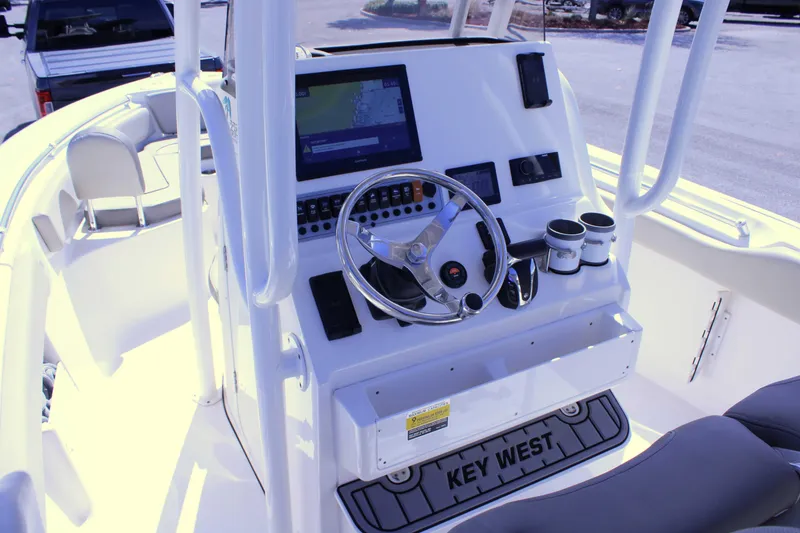 Slide: The Image of 2021 Key West 239 FS boat console with steering wheel and navigation display. - 11
