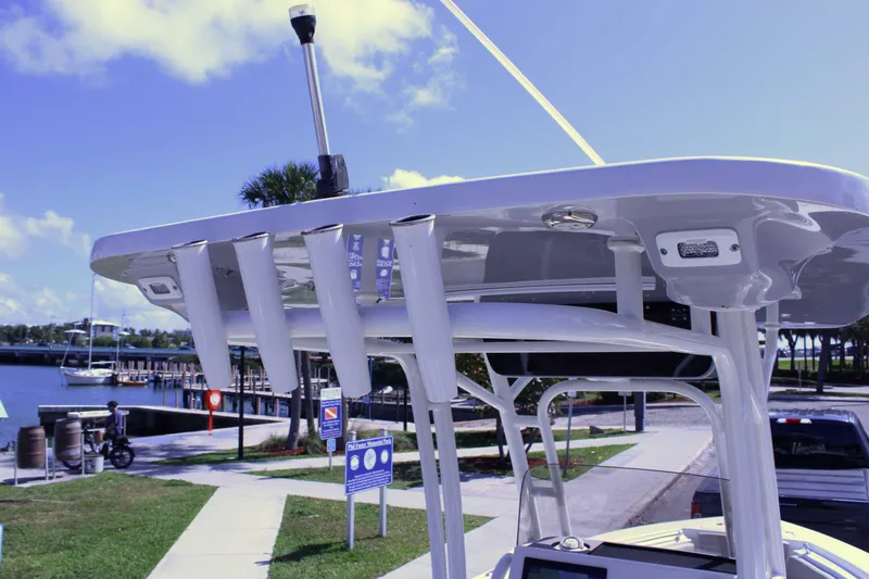 Slide: The Image of 2021 Key West 239 FS boat with T-top and rod holders at a marina. - 17