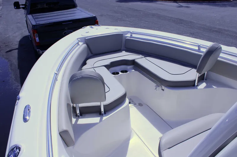 Slide: The Image of 2021 Key West 239 FS boat interior with cushioned seating and cup holders. - 18