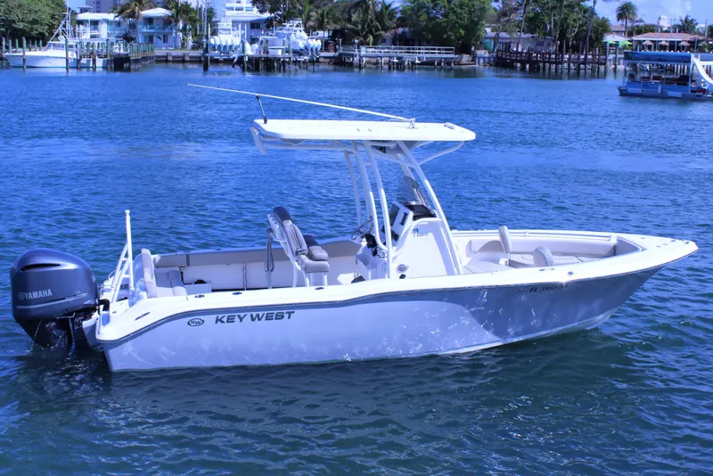 Slide: The Image of 2021 Key West 239 FS boat on calm water with Yamaha engine. - 2