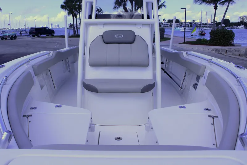 Slide: The Image of 2021 Key West 239 FS boat interior with seating, docked near a scenic waterfront. - 22