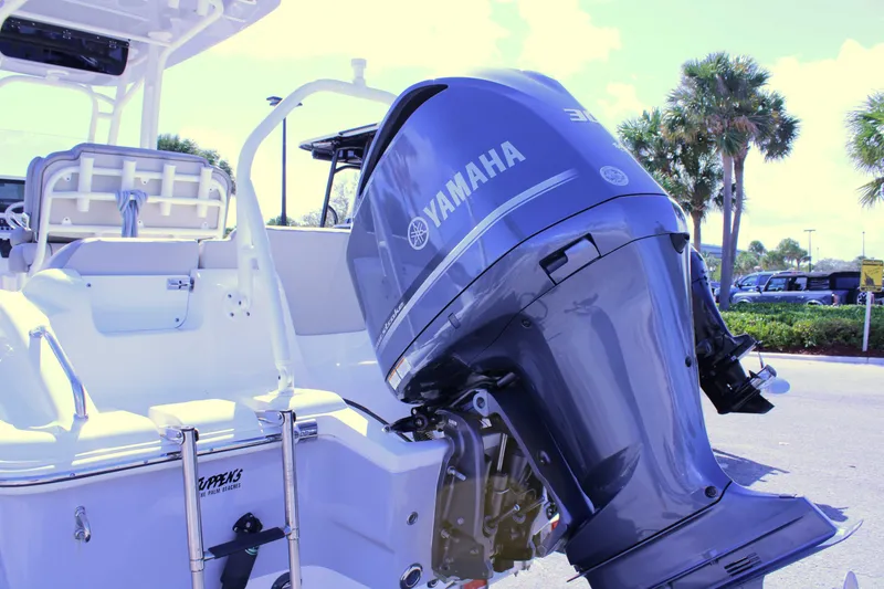 Slide: The Image of 2021 Key West 239 FS boat with Yamaha outboard motor, parked outdoors. - 27