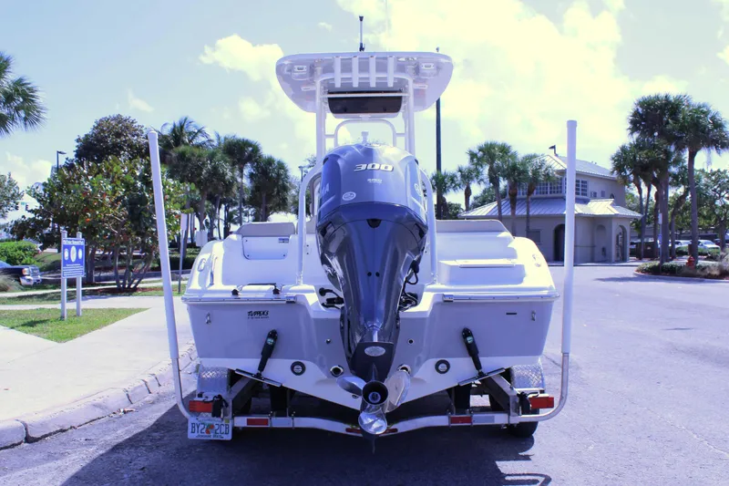 Slide: The Image of 2021 Key West 239 FS boat with 300 HP engine, parked near palm trees. - 4