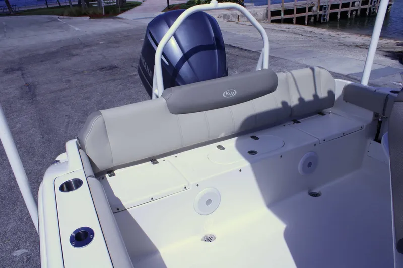 Slide: The Image of 2021 Key West 239 FS boat interior with Yamaha engine, dockside view. - 6
