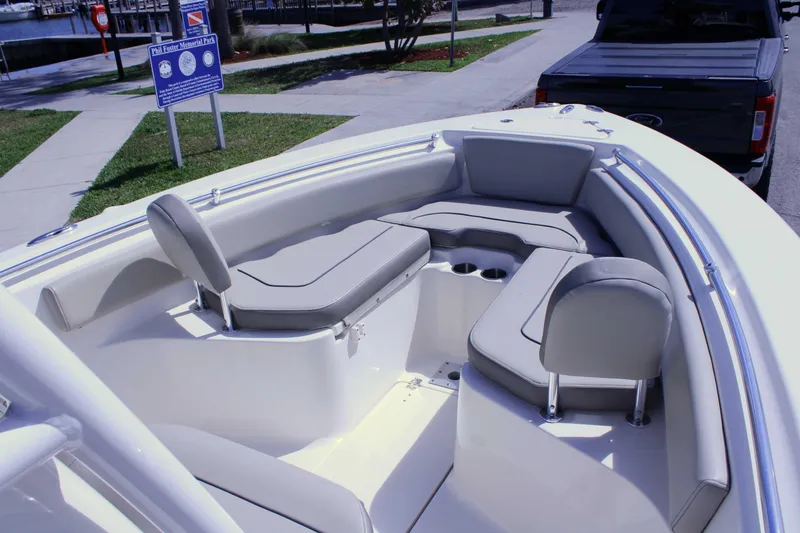 Slide: The Image of 2021 Key West 239 FS boat interior with cushioned seating and cup holders. - 8
