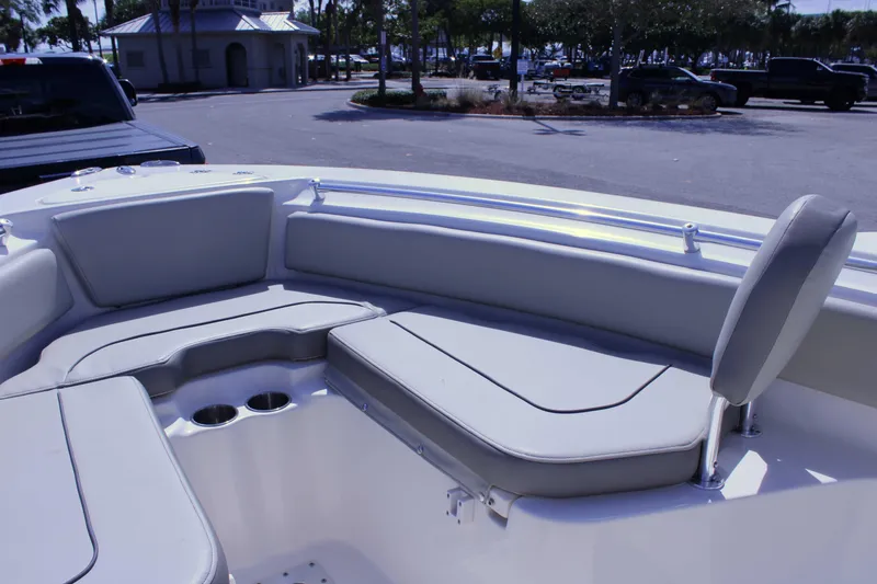 Slide: The Image of 2021 Key West 239 FS boat interior with cushioned seating and cup holders. - 9