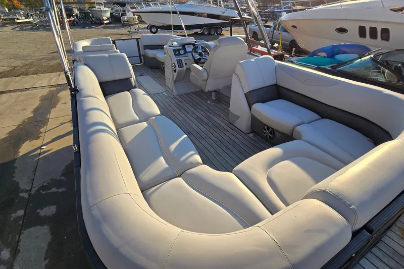 Slide: The Image of 2017 Crest Classic 230 SLC pontoon boat with spacious seating and modern interior design. - 12