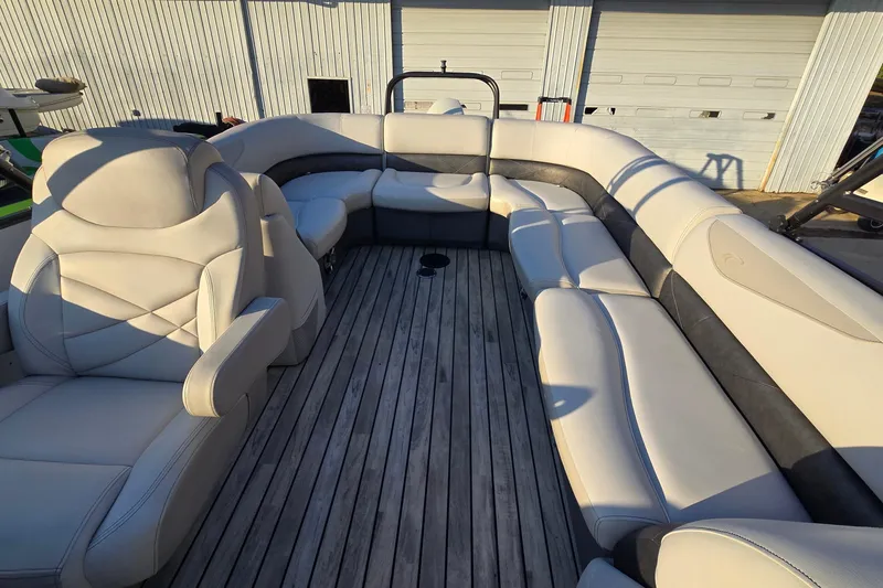 Slide: The Image of 2017 Crest Classic 230 SLC boat interior with luxurious seating and wooden flooring. - 13