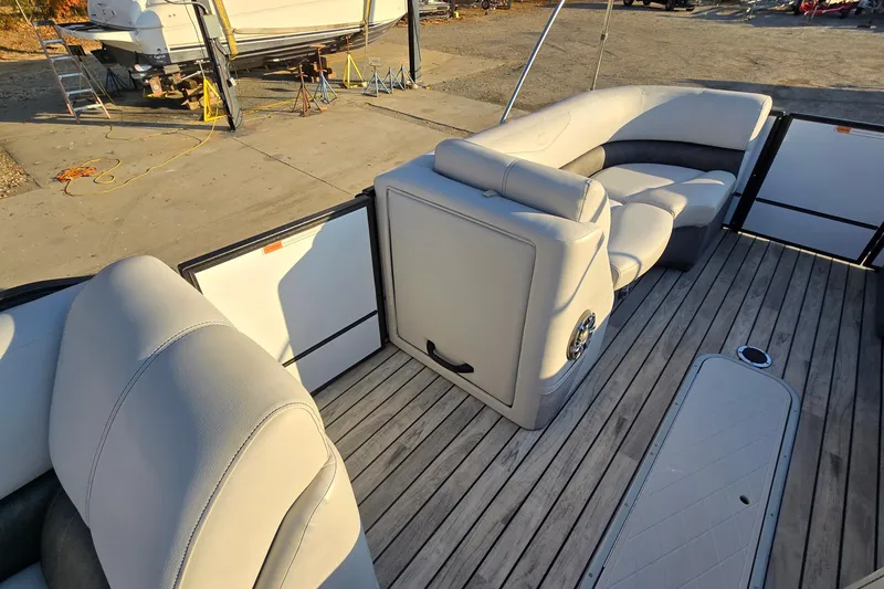 Slide: The Image of 2017 Crest Classic 230 SLC boat interior with plush seating and wooden deck. - 15