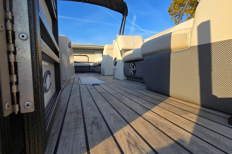 Slide: The Image of 2017 Crest Classic 230 SLC boat interior with wood flooring and cushioned seating. - 21