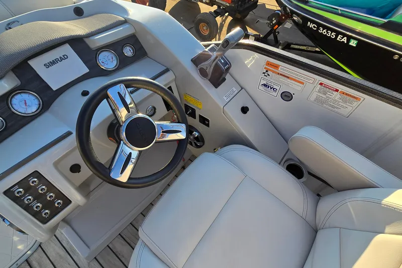 Slide: The Image of 2017 Crest Classic 230 SLC boat dashboard with steering wheel and controls. - 23