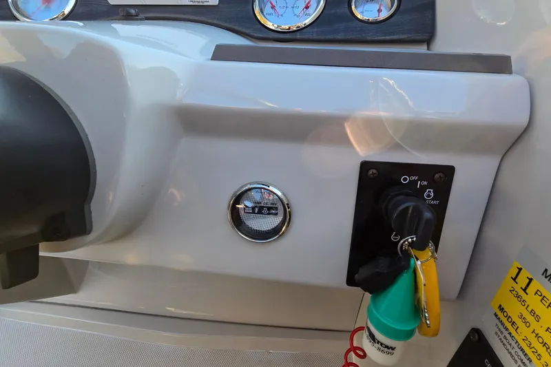 Slide: The Image of Control panel of 2017 Crest Classic 230 SLC boat with ignition and gauges. - 24