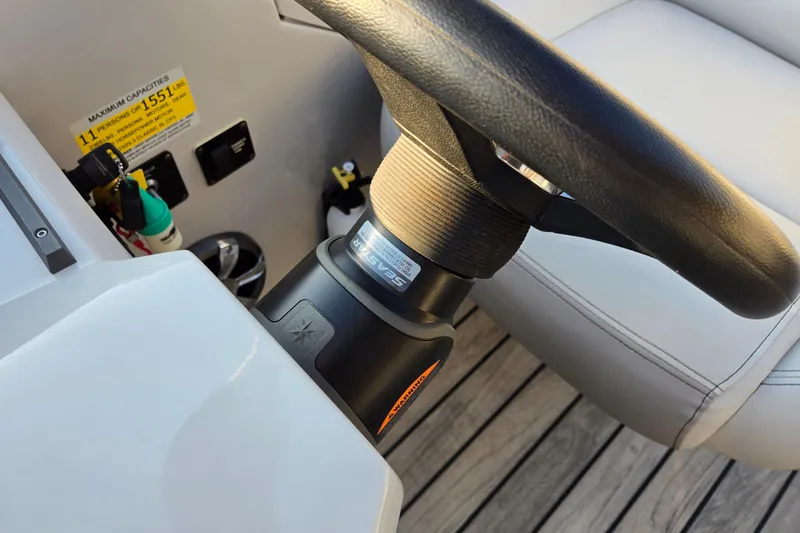 Slide: The Image of Steering wheel of 2017 Crest Classic 230 SLC boat, showcasing controls and seating. - 27