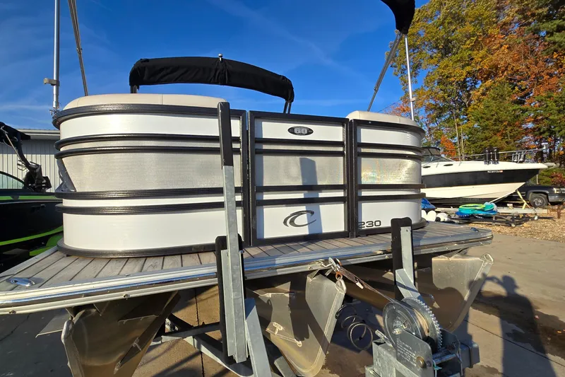 Slide: The Image of 2017 Crest Classic 230 SLC pontoon boat on trailer, sunny day, autumn trees in background. - 3