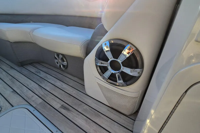 Slide: The Image of 2017 Crest Classic 230 SLC boat interior with sleek speaker and cushioned seating. - 35