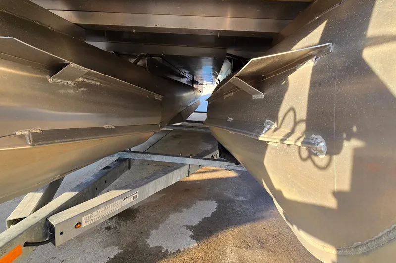 Slide: The Image of Underneath view of a 2017 Crest Classic 230 SLC pontoon boat on a trailer. - 47