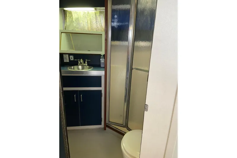 Slide: The Image of 1987 Carver 32 Montego bathroom with sink, shower, and toilet. - 12