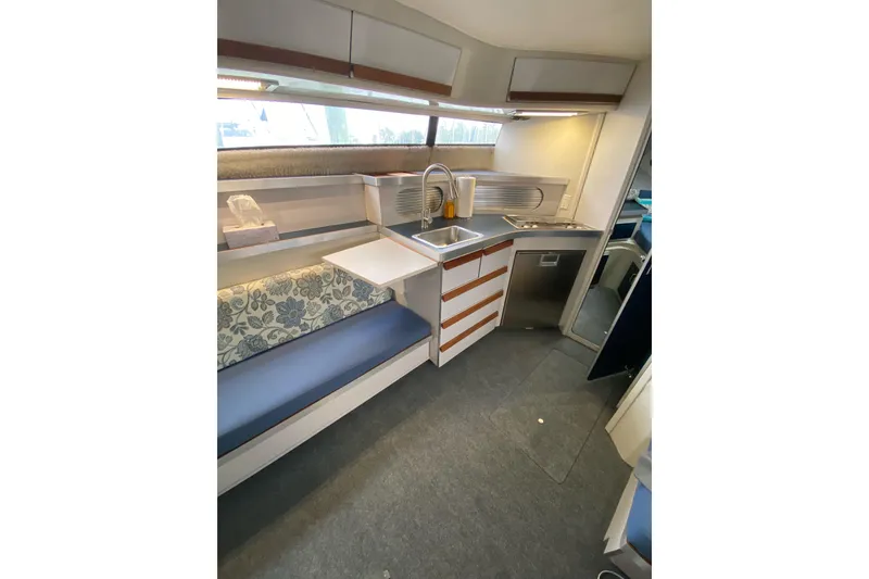 Slide: The Image of Interior of 1987 Carver 32 Montego boat with kitchenette and seating area. - 13