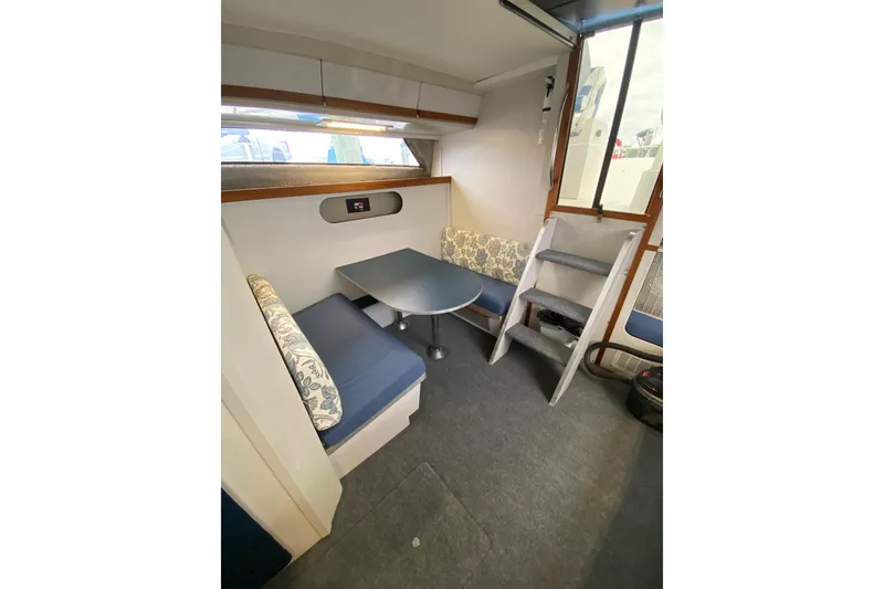 Slide: The Image of Interior of 1987 Carver 32 Montego boat with seating area and table. - 14