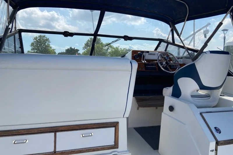 Slide: The Image of Interior view of 1987 Carver 32 Montego boat cockpit with steering wheel and seating. - 7