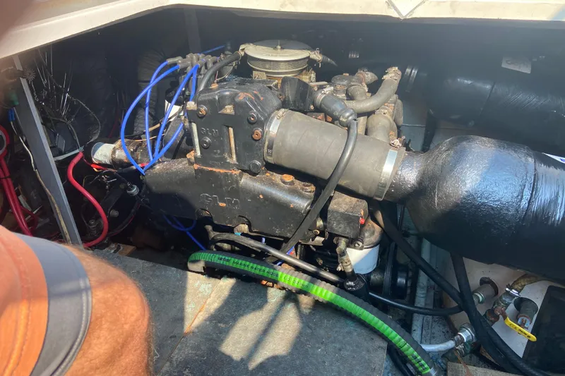 Slide: The Image of Engine compartment of a 1987 Carver 32 Montego boat, showing mechanical components and wiring. - 17