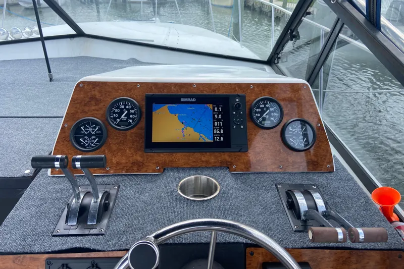 Slide: The Image of Dashboard of a 1987 Carver 32 Montego boat with navigation system and controls. - 4