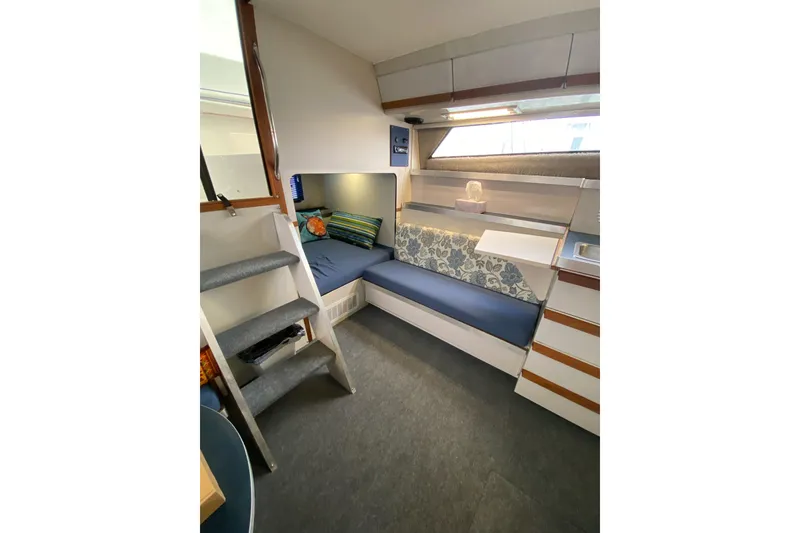 Slide: The Image of Interior of 1987 Carver 32 Montego boat with cozy seating and modern decor. - 9