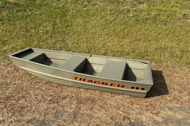 Slide: The Image of 2026 Tracker Grizzly 10 Jon boat on grass, showcasing durable design and compact size. - 8