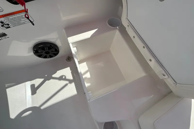 Slide: The Image of Interior of 2026 Tahoe T16 boat showing storage compartment and speaker. - 20