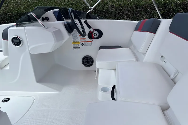 Slide: The Image of 2026 Tahoe T16 boat interior with white seating and steering console. - 17