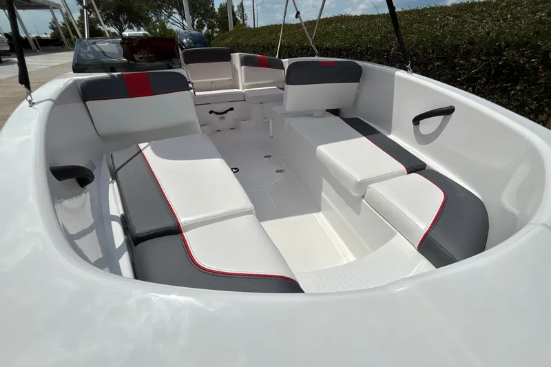 Slide: The Image of 2026 Tahoe T16 boat interior with sleek white and gray seating, red accents. - 9