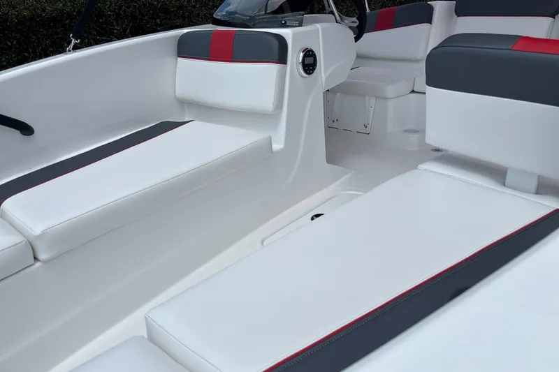 Slide: The Image of 2026 Tahoe T16 boat interior with white and gray seating, red accents. - 8