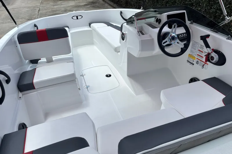 Slide: The Image of 2026 Tahoe T16 boat interior with modern seating and steering wheel design. - 11