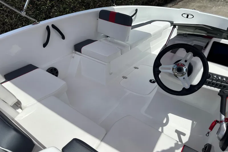 Slide: The Image of 2026 Tahoe T16 boat interior with white seating and modern steering wheel design. - 12