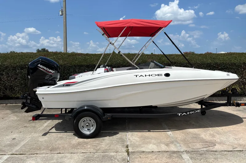 Slide: The Image of 2026 Tahoe T16 boat with red canopy and Mercury engine on trailer. - 3