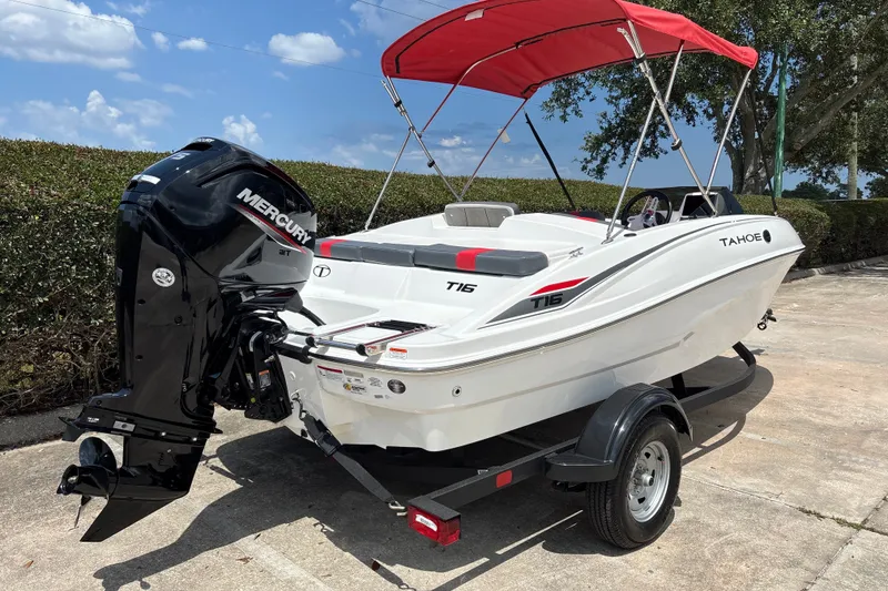 Slide: The Image of 2026 Tahoe T16 boat with Mercury engine and red canopy on trailer. - 4