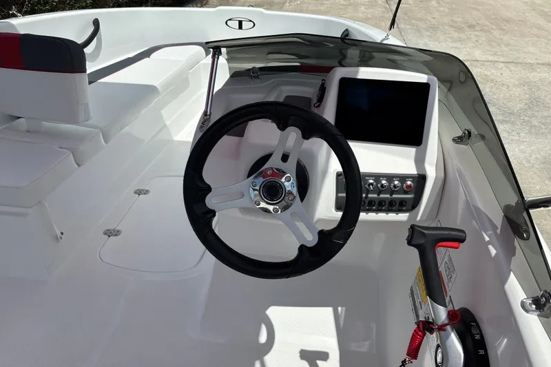 Slide: The Image of 2026 Tahoe T16 boat cockpit with steering wheel, control panel, and seating. - 15