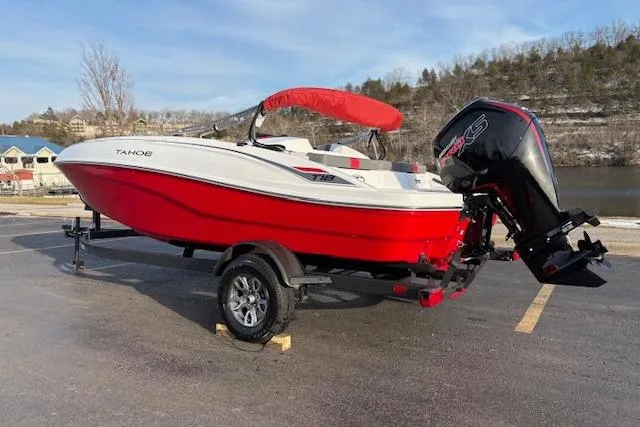 Slide: The Image of 2026 Tahoe T18 boat with red hull and outboard motor on trailer. - 74