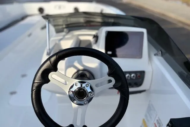 Slide: The Image of 2026 Tahoe T18 boat cockpit with steering wheel and control panel. - 77