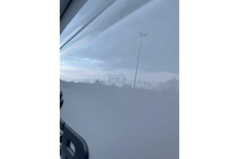 Slide: The Image of Reflection on Tahoe T18 boat surface, showcasing a cloudy sky, 2026 model. - 82