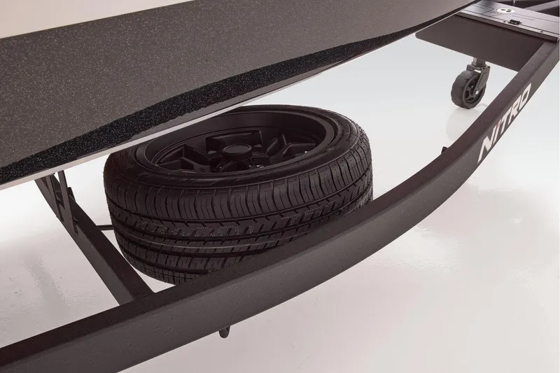 Slide: The Image of 2026 Nitro Z21 XL boat deck with gray carpet and storage compartments. - 11