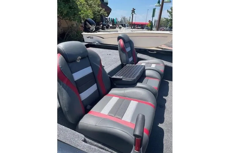 Slide: The Image of 2026 Ranger RT188P boat interior with gray and red seating, outdoor setting. - 12