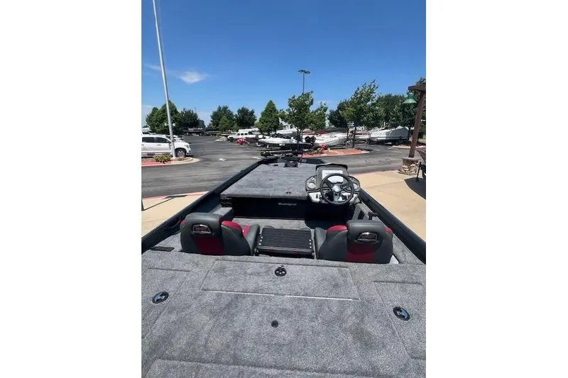 Slide: The Image of 2026 Ranger RT188P boat interior with steering wheel, seats, and spacious deck under clear sky. - 14